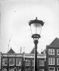 351211 Afbeelding van een straatlantaarn op de Oudegracht te Utrecht, met op de achtergrond de voorgevels van de panden ...